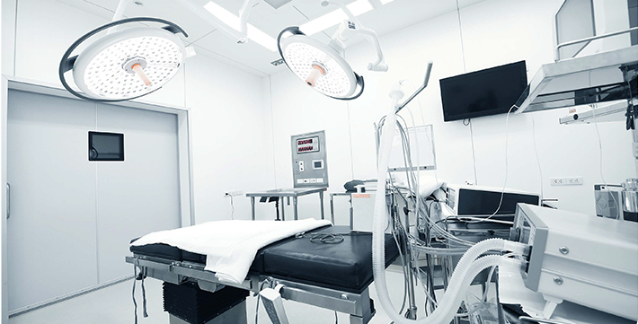 A clean, brightly lit, slightly out-of-focus background showing a portion of a medical consultation room